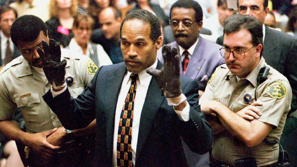 OJ Simpson holds up his hands to the jury showing leather gloves that prosecutors say he wore the night of the murders during his trial in Los Angeles in 1995. File photograph: Sam Mircovich/Reuters