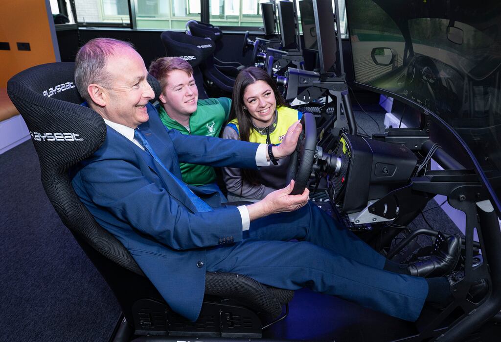 Taoiseach Micheál Martin with Kayls Cole, Formula 1000 racing driver, and Daire McCormack, professional esports driver, on Logitech Pro Racing SIMs at the official opening of Ireland's first dedicated esports complex.