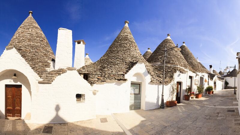 Dotted around the Puglia countryside are trulli, distinctive little conical stone houses, a bit like pointer beehive huts. Photograph: Getty