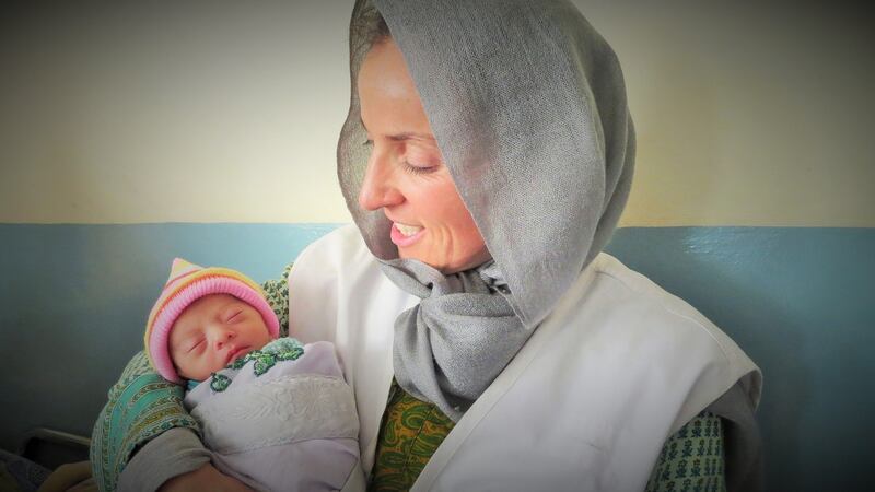 Médicins Sans Frontières nurse Aoife Ní Muruchu holds a newborn at MSF’s maternity hospital in Khost province, Afghanistan. Photograph: Pau/MSF