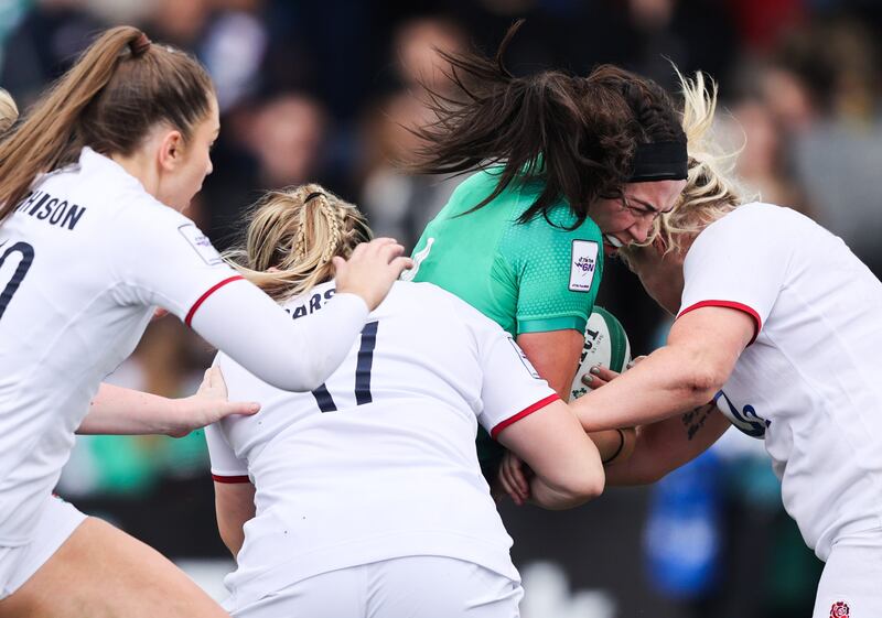 Ireland's Nichola Fryday is tackled by Holly Aitchison, Mackenzie Carson and Marlie Packer of England at Musgrave Park. Photograph: Tom Maher/Inpho
