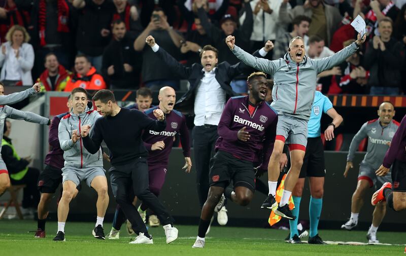 Xabi Alonso and his side celebrate as Josip Stanisic scores a last-minute goal against Roma in Europa League semi-final in Leverkusen. Photograph: Stefan Matzke/Getty Images