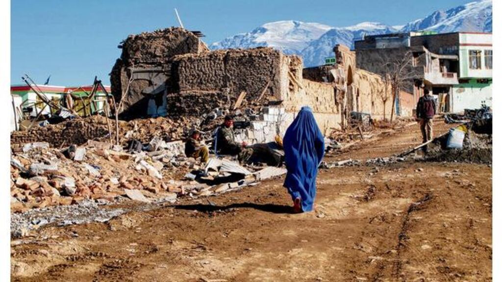 Survivors: a woman walks through the rubble of a suicide bomb in Wardak province. photograph: pam constable/the washington post via getty images