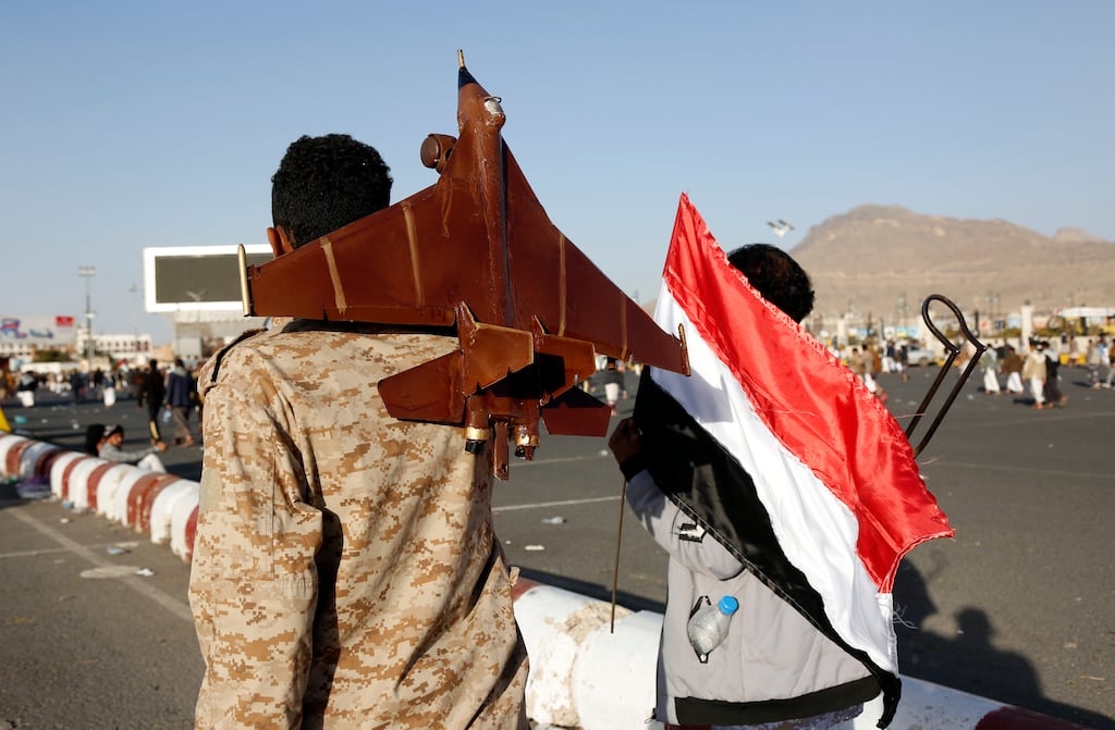 A man holding Yemen's national flag and another carrying a mock jet walk to participate in a protest in Sana'a on Friday against air strikes by US and British forces. Photograph: Mohammed Hamoud/Getty Images