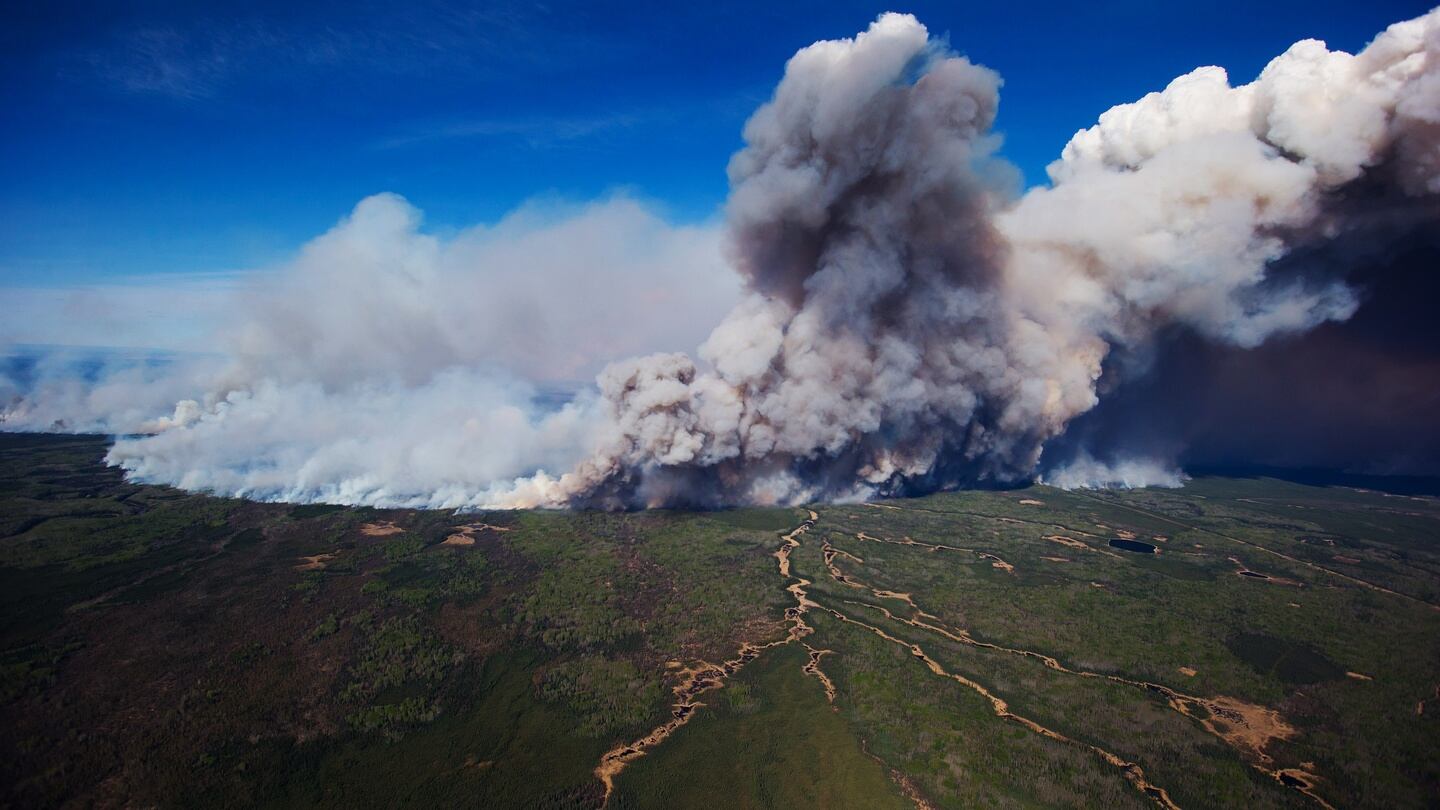 A huge plume of smoke from wildfires burning rises in this aerial photograph taken above Fort McMurray. Photograph: Bloomberg
