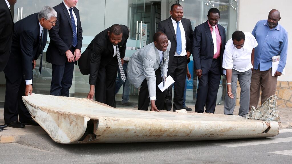 Tanazanian officials with a piece of debris from the missing Malaysia Airlines Flight MH370. Photograph: Stringer/Reuters