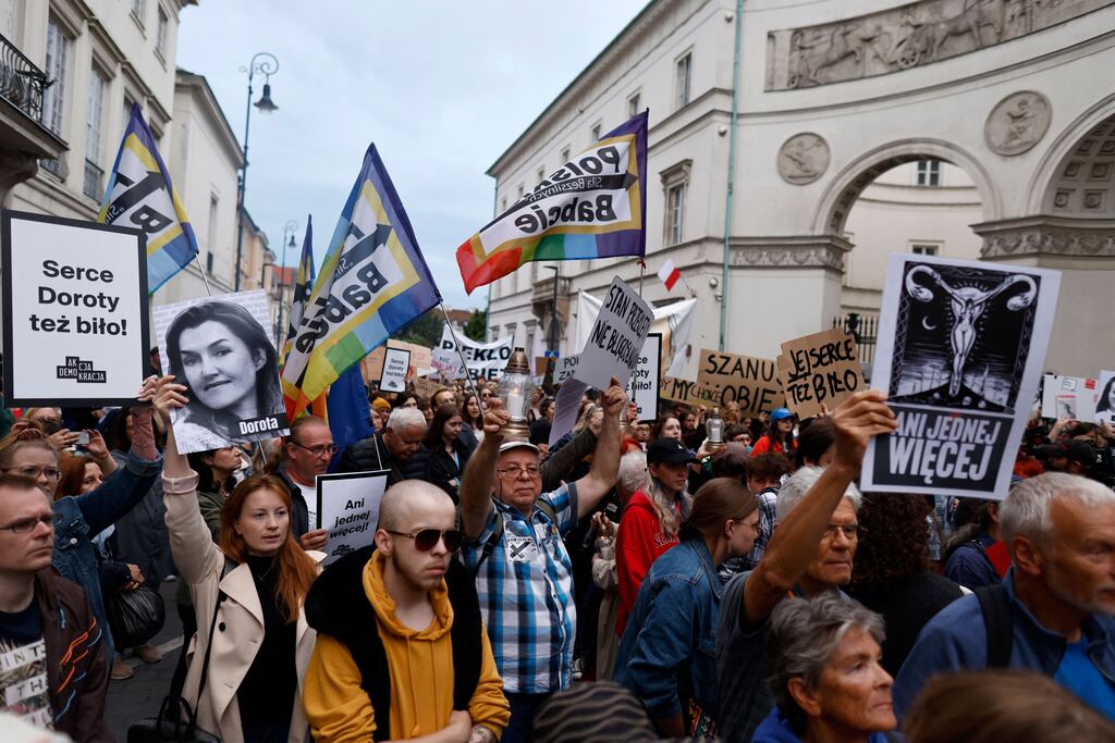 A demonstrator (second from left) in Warsaw holds up an image showing late Dorota Lalik, who died in her fifth month of pregnancy, as people take to the streets to protest under the slogans 'Not one more' and 'Stop killing us' against Polish legislation on abortion. Photograph: Wojtek Radwanski/AFP via Getty Images