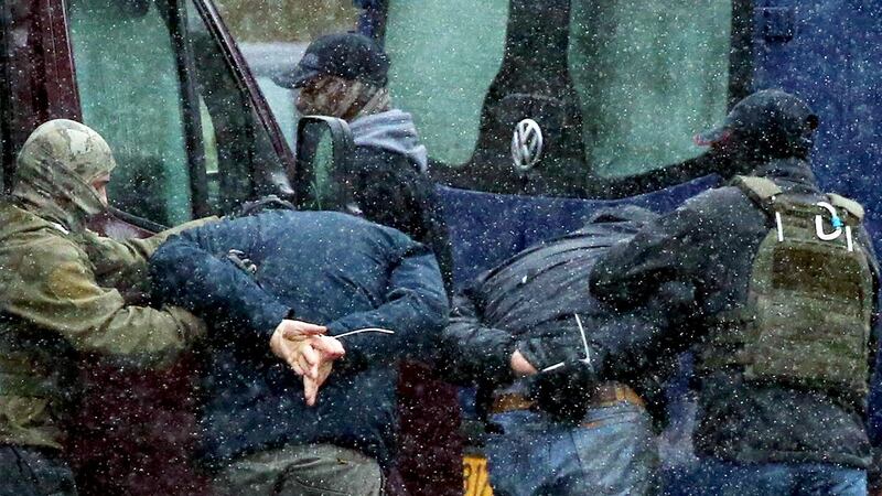 Law enforcement officers detain two men as opposition supporters rally in Minsk. Photograph: Stringer / AFP via Getty
