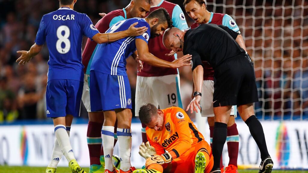 Referee Anthony Taylor looks on as West Ham’s Adrian reacts after a tackle from Chelsea’s Diego Costa. Photograph: Eddie Keogh/Reuters