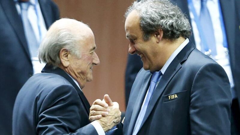 UEFA president Michel Platini (right) congratulates Fifa president Sepp Blatter after he was re-elected at the 65th Fifa Congress in Zurich, Switzerland, on Friday. Photograph: Reuters