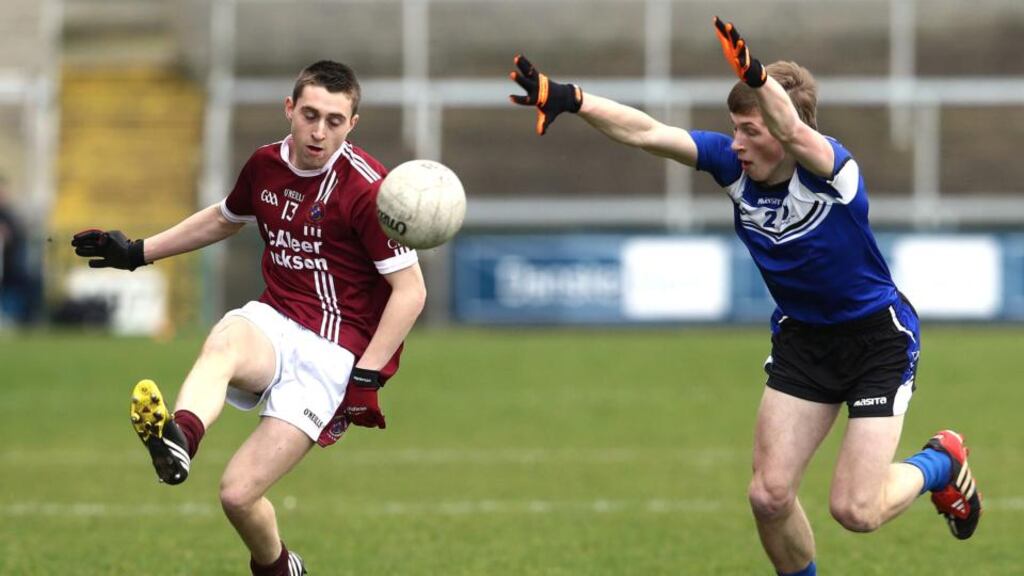 St Patrick’s Paul McNeill with Omagh’s Michael Corles. Photograph: Inpho/Presseye/William Cherry