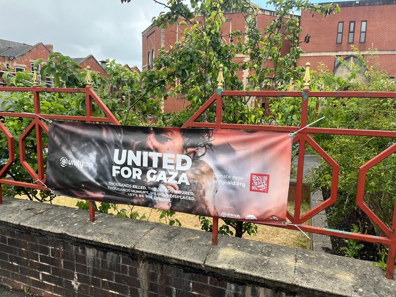 A sign rallying support for Gaza on the railings of Rochdale's central mosque. Photograph: Mark Paul