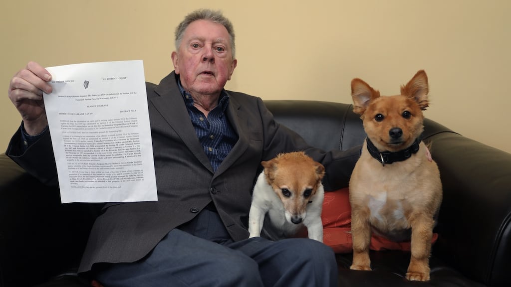 Jude McGovern with his dogs Foxy & Harry and the search warrant left by Garda at his home. Photograph: Lorraine Teevan