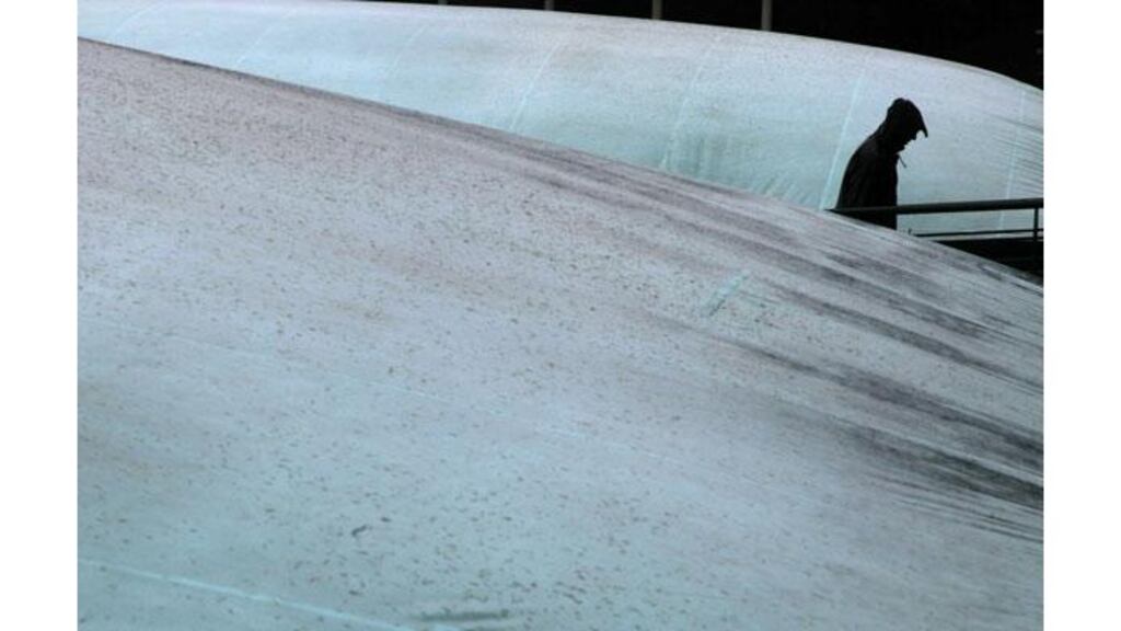 The covers go up again at Wimbledon as persistent rain keeps the players off court. Photograph: Stefan Wermuth/Reuters