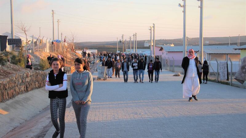 Residents of the Midyat camp pass the time on a walkway thronged with groups of idle young men and women. Photograph: Stephen Starr