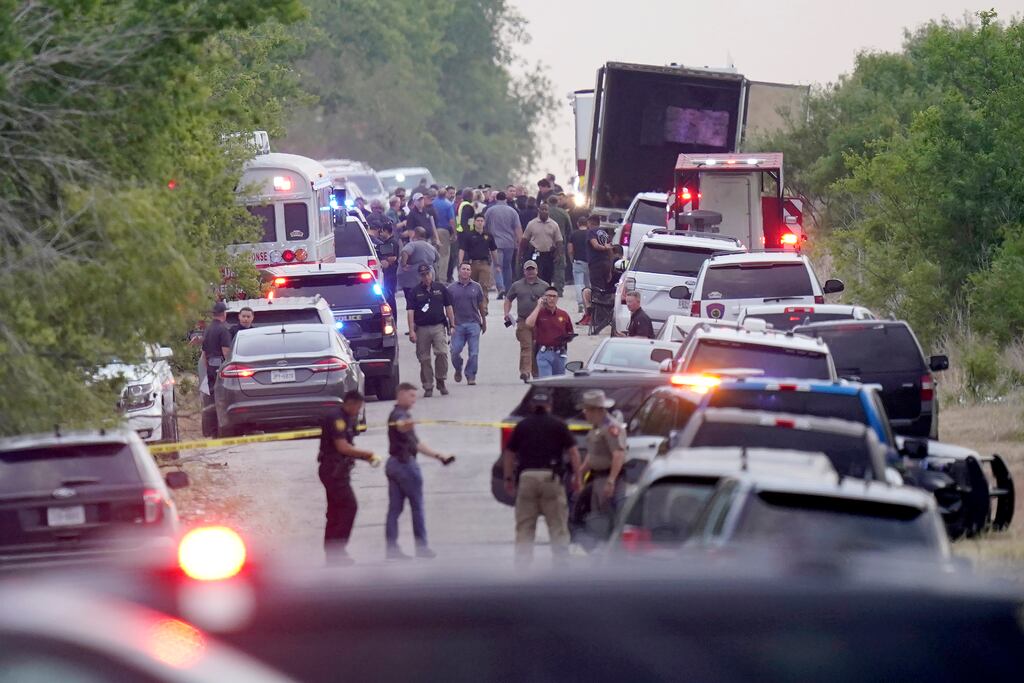 Investigators at the scene where dozens of migrants were found dead on Monday in San Antonio, Texas. The death toll rose to at least 50 on Tuesday morning, with two more victims confirmed dead at a hospital in San Antonio. Photograph: Lisa Krantz/The New York Times