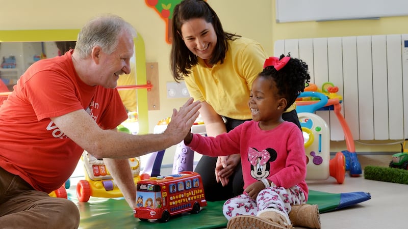 Volunteer Ainnle O’Neill and play specialist Emma Fratangelo with Amisa Tambwe (4) from Cavan. Photograph: Alan Betson
