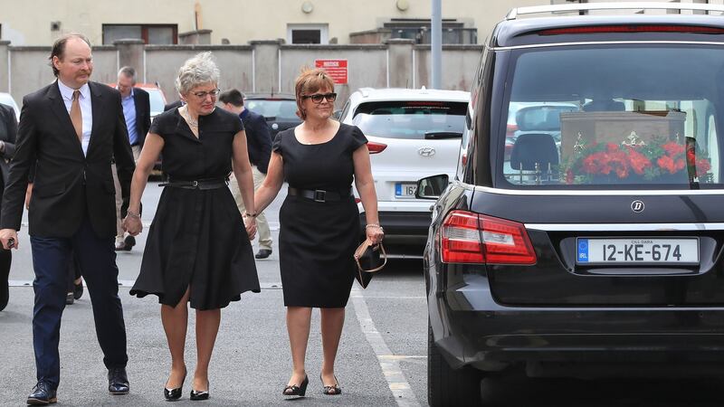 Minister for Children and Youth Affairs Katherine Zappone pictured with her brother in law, Mark Zappone and sister in law, Suzanne Zappone Hoover at An Cosán, Jobstown, Dublin at the wake of her wife Ann Louise Gilligan. Photograph: Colin Keegan, Collins Dublin