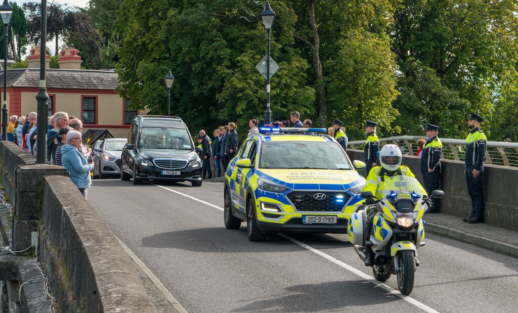 The cortege returning Detective Garda Deirdre Finn to Dublin passing through Carrick on Shannon, Co Leitrim, on Tuesday evening with a Garda escort. Garda and Shannon Boat Rally colleagues also provided a guard of honour on Carrick Bridge. Photograph: Gerry Faughnan