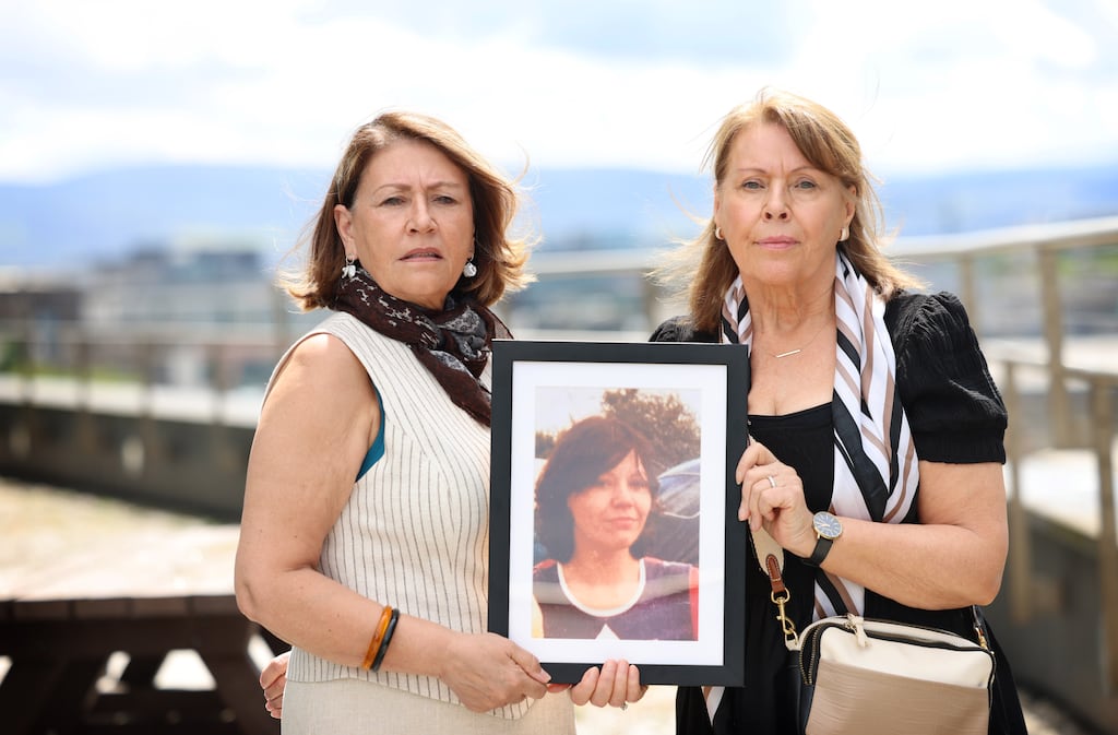 Kathleen Nolan and Bernadette Barry with a photograph of their sister Elizabeth Plunkett, who was murdered by John Shaw and Geoffrey Evans in 1976. Photograph: Dara Mac Dónaill