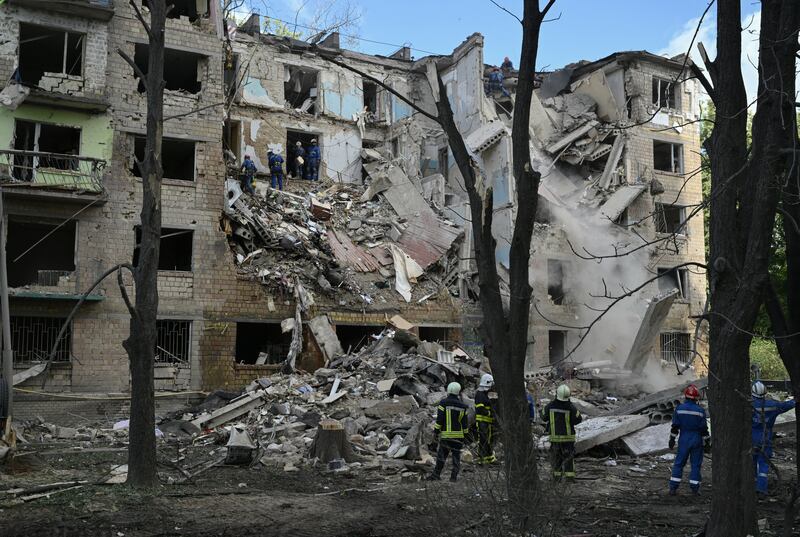 Ukrainian rescuers work at the bottom of a residential building, heavily damaged following a strike in Kyiv. Photograph: Genya Savilov/AFP via Getty