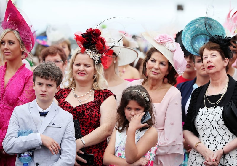 Orla Forde-Wilson (fourth right) and her daugther Alexandria (third right), from Galway, watch the catwalk during day four of the Galway races. Photograph: Brian Lawless/PA Wire