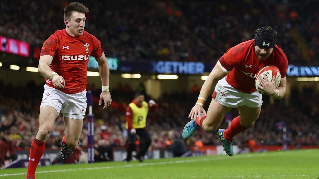 Wales’s Leigh Halfpenny, supported by Josh Adams, dives over to score his second try during the match against Scotland at the Principality Stadium, Cardiff, Wales. Photograph: Michael Steele/Getty Images