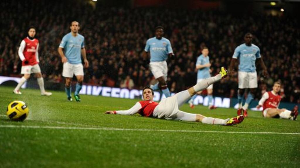 Robin Van Persie can’t quite stretch enough to meet Jack Wilshere’s cross early in tonight’s contest. Photograph: Dylan Martinez/Reuters