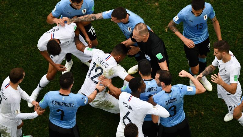 Players crowd around Kylian Mbappe after he went down.Photo: Antonin Thulier/Getty Images