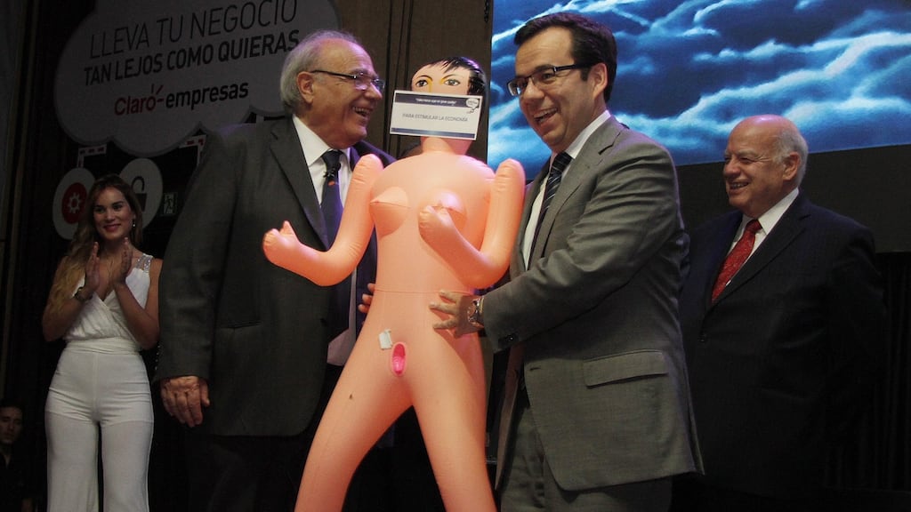 Minister for the economy of Chile Luis Felipe Cespedes (right) receives an inflatable doll from president of the Association of Exporters of Manufactures (Asexma) Roverto Fantuzzi in Santiago, Chile. Photograph: EPA