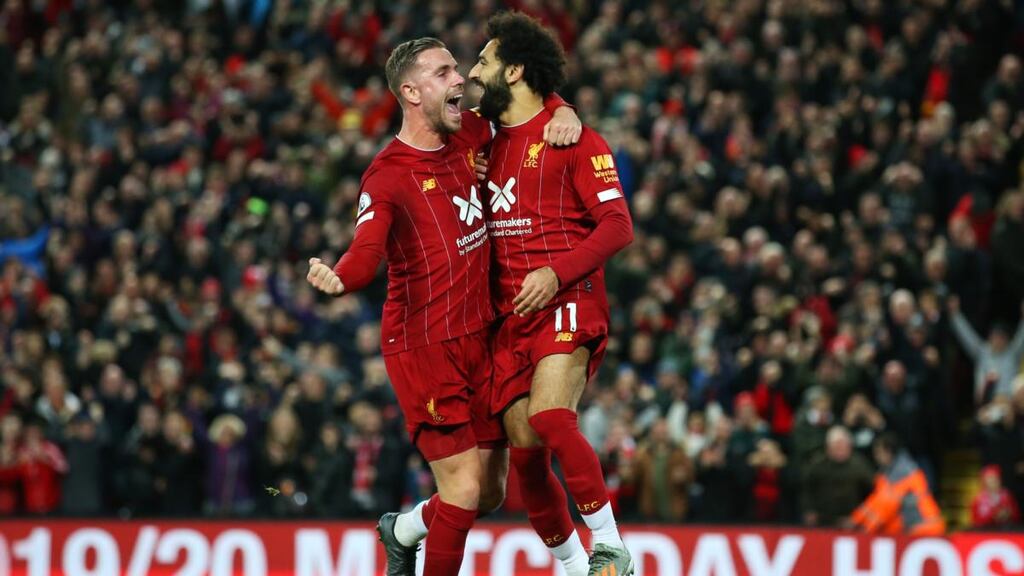 Mohamed Salah celebrates with Jordan Henderson after scoring his side’s second goal in the Premier League game against Tottenham Hotspur at Anfield. Photograph: Jan Kruger/Getty Images
