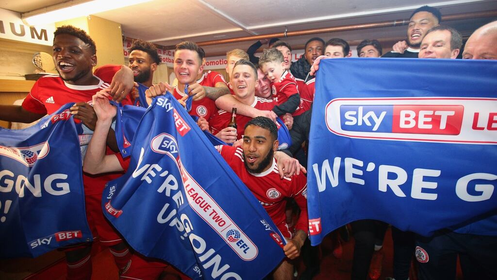 Accrington Stanley players celebrate their promotion to League One. Photograph: Alex Livesey/Getty