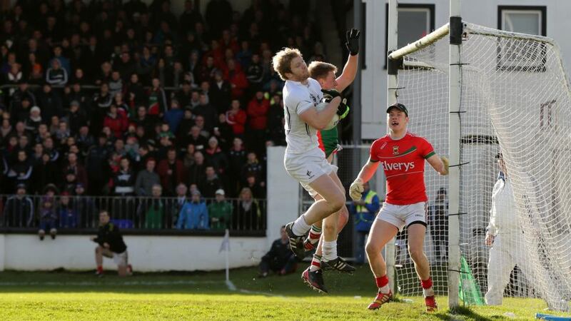 Kildare’s Tomas O’Connor gathers a high ball while under pressure from Kevin Keane of Mayo. Photograph: Cathal Noonan/Inpho