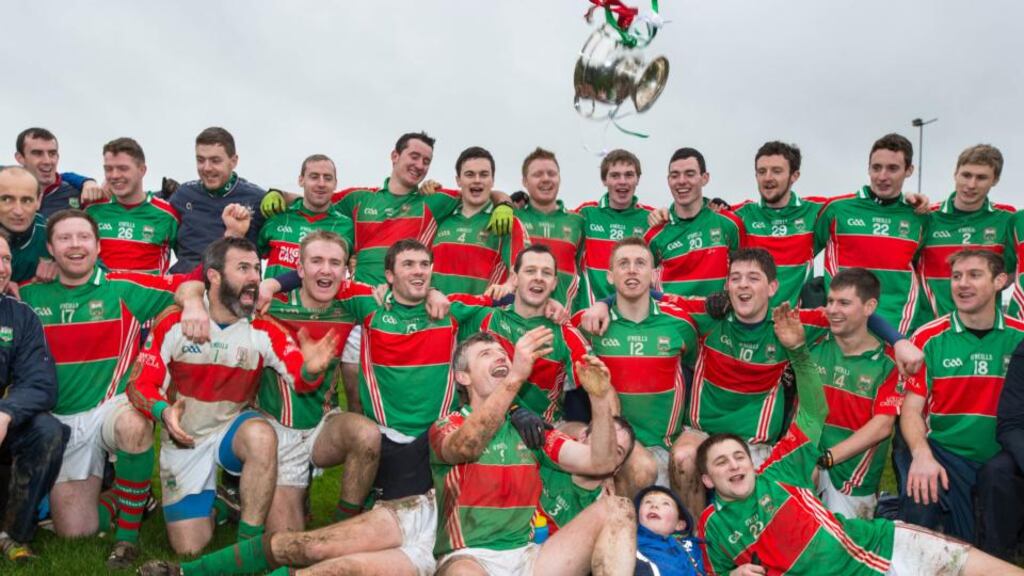 David Kennedy and Loughmore Castleiney players celebrate with the cup after beating Cahir in the replayed Tipperary SFC final. Photograph: Cathal Noonan/Inpho