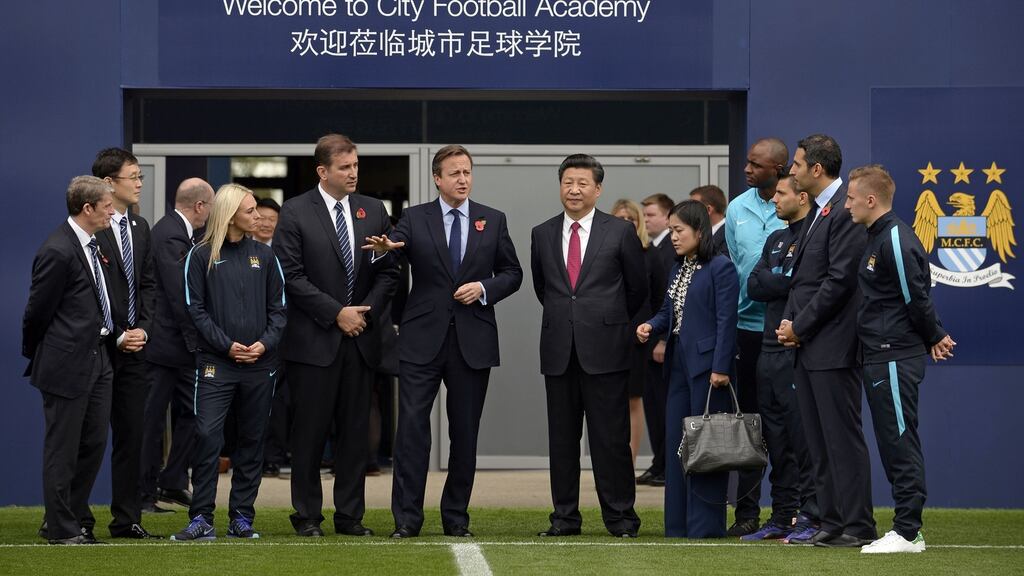British Prime Minister David Cameron and Chinese President Xi Jinping during a visit to the City Football Academy in Manchester. Photograph: Joe Giddens/AFP/Getty Images
