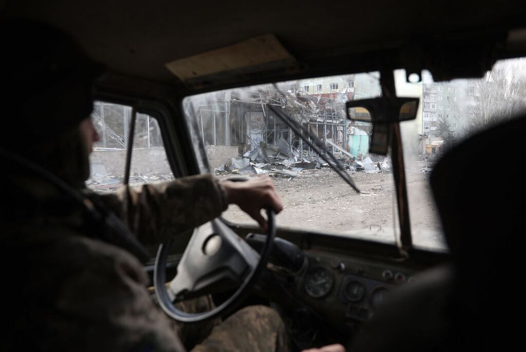 A Ukrainian serviceman drives a vehicle in the city of Bakhmut, in the Donetsk region. Photograph: Anatolii Stepanov/AFP via Getty