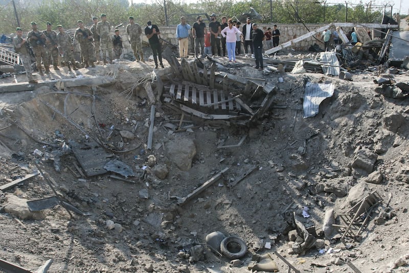Lebanese soldiers and local residents stand at the site of an Israeli airstrike in the village of Toura on Thursday. Photograph: Mahmoud Zayyat/AFP/Getty Images