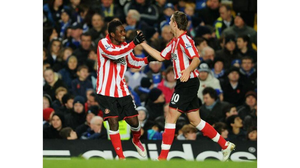 Sunderland’s Asamoah Gyan is congratulated by Jordan Henderson after doubling the visitor’s lead at Stamford Bridge. Photograph: Michael Regan/Getty Images