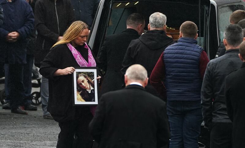 Leona Harper's mother Donna carries a photo of her as her coffin arrives at St Mary's Church in Ramelton, Co Donegal. Photograph: Brian Lawless/PA