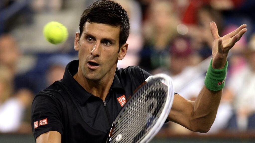 Novak Djokovic in action against Victor Hanescu from Romania at the BNP Paribas Open tennis in Indian Wells. Photograph: Michael Nelson/EPA ,