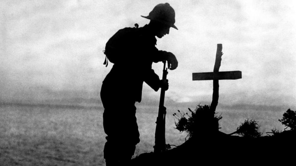 A British soldier paying his respects in 1915 at the grave of a colleague near Cape Helles, where the Gallipoli landings took place. Photograph: PA