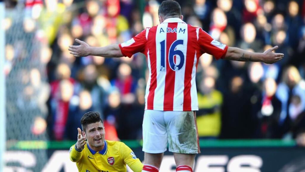 Arsenal’s Olivier Giroud  argues with Stoke City’s Charlie Adam  during the  Premier League match  at the Britannia Stadium. Photograph: Laurence Griffiths/Getty Images