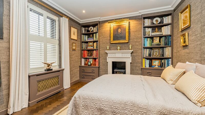 The front room, now a guest bedroom/study, is accessed via glass-panelled sliding doors