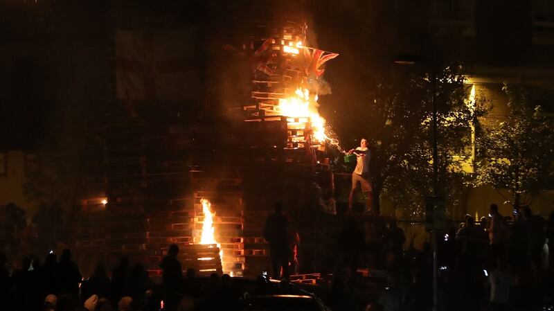 A man lights the bonfire to mark the anniversary of the introduction of the controversial policy of internment without trial. Photograph: PA Wire