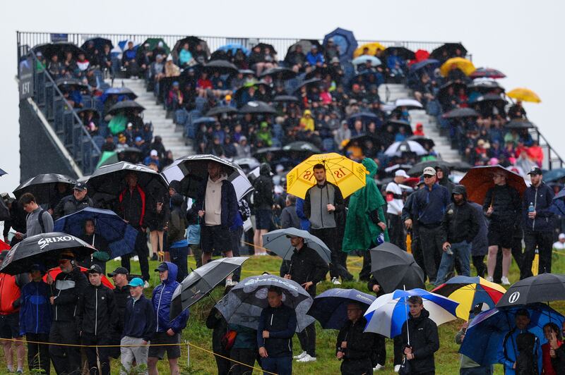Spectators under umbrellas on the first day of the Open Championship at Royal Portrush Golf Club on Thursday. Photograph: Ben Brady/Inpho
