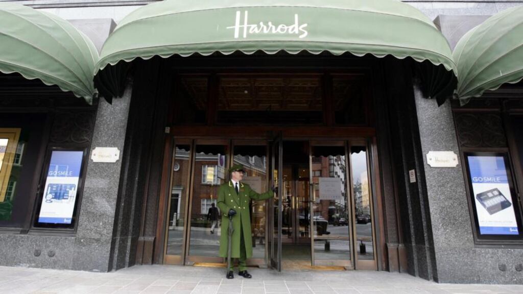 A doorman outside the Harrods department store in London. The store is a regular visiting place for tourists looking to buy luxury goods.