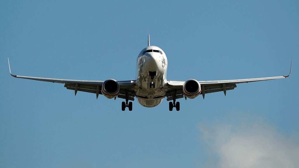A Boeing 737-800 aircraft prepares to land. The company said it will cut 4,000 jobs in an attempt to control costs. Photographer: Brendon Thorne/Bloomberg