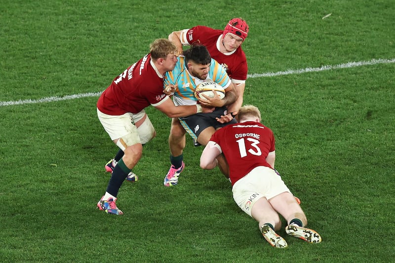 Jarrah McLeod of the First Nations and Pasifika is tackled by Jac Morgan, Josh van der Flier and Jamie Osborne of the British and Irish Lions at Marvel Stadium. Photograph: Mike Owen/Getty Images