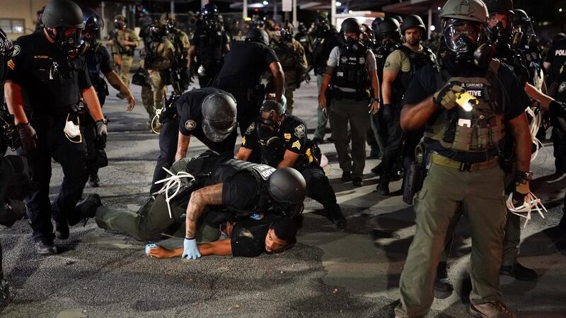 Police detaining a protester after the killing of George Floyd, on May 30th, 2020 in Atlanta, Georgia. Photograph:  Elijah Nouvelage/Getty Images