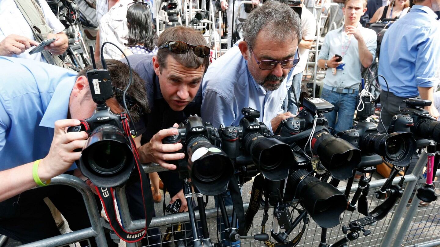 Photographers fix remote-controlled camera to a pen in front of the Lindo Wing of St Mary’s Hospital. Photograph: Suzanne Plunkett/Reuters